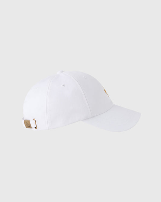 White baseball cap with pom pom on crown, tan adjustable back strap with metal hardware.