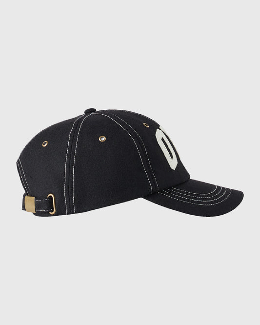 Black wool cap with white "OVO" logo on side, white contrast stitching, and brass buckle back closure.