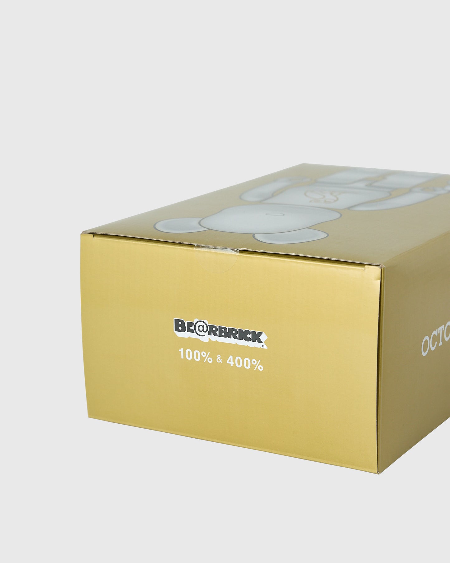 Yellow BE@RBRICK box with pearl white figures visible on top lid, labeled "100% & 400%".