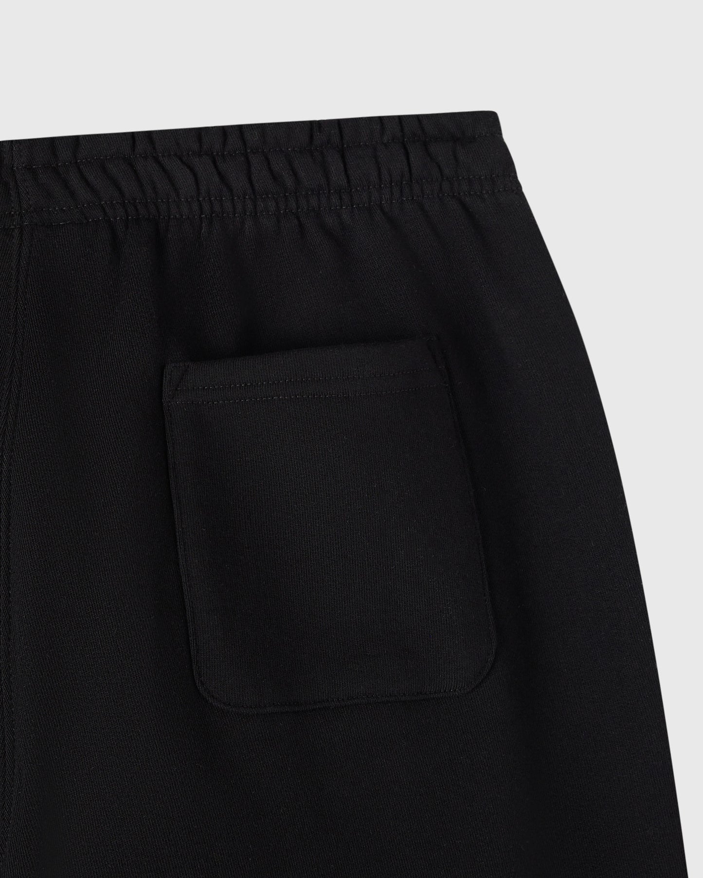 Black sweatpants with elastic waistband and front pocket detail.