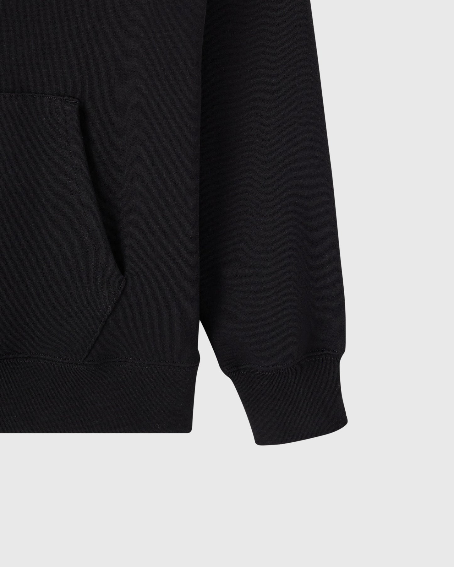 Black hoodie with kangaroo pocket and ribbed cuffs, shown from side detail view.