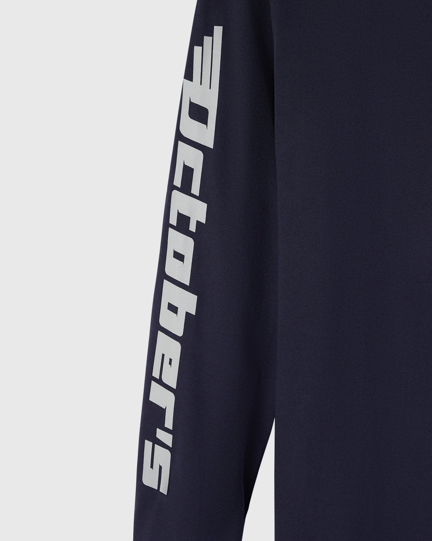 Navy long-sleeve tee with white Red Bull Racing logo and text printed down the sleeve.