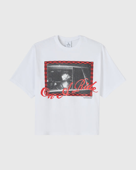 White t-shirt with black and white photo print surrounded by red heart border and red text overlay.