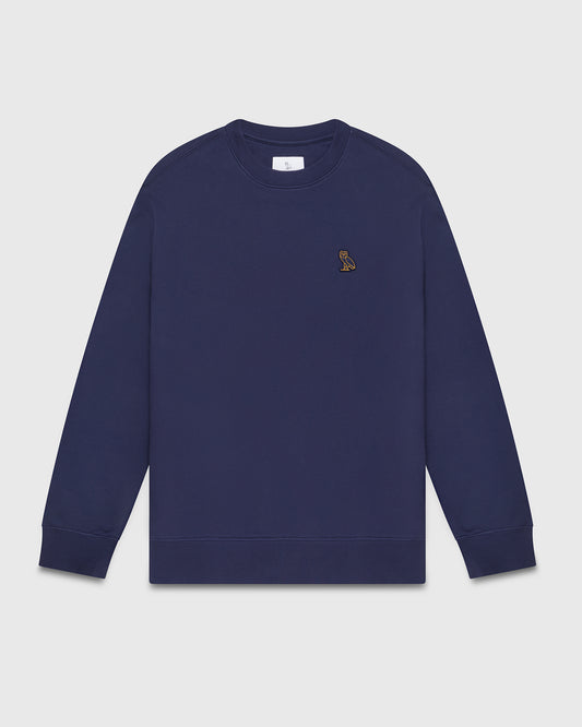 Navy crewneck sweatshirt with small embroidered owl logo on chest.