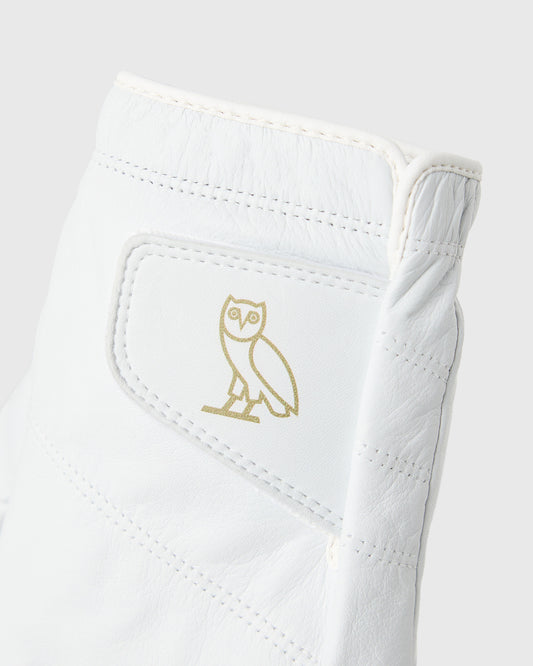 White golf glove with gold owl logo and stitched details on palm and back.