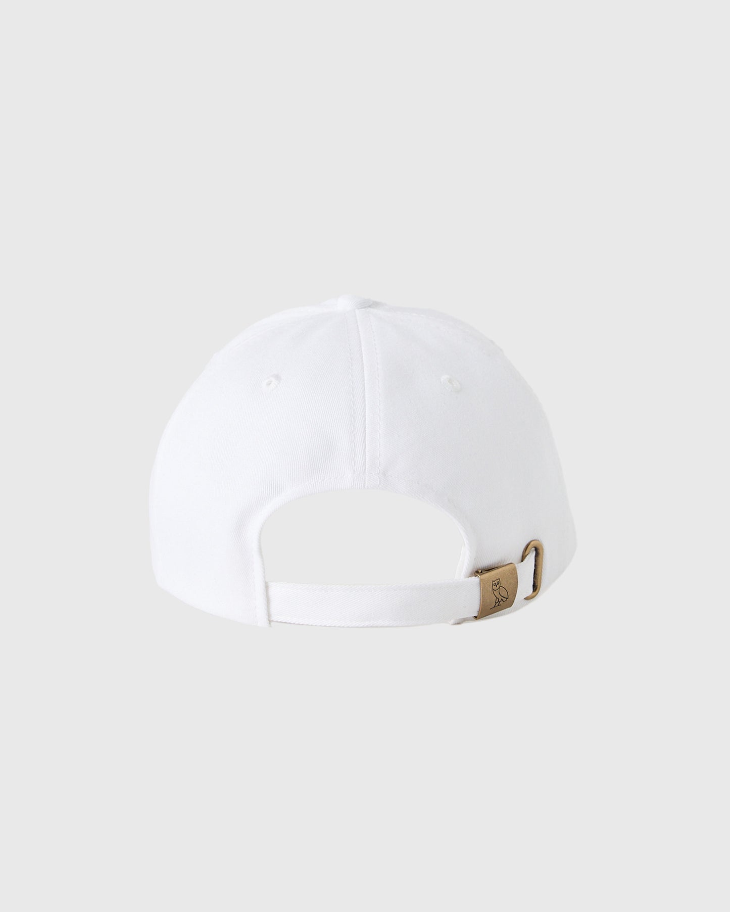 White baseball cap with six-panel construction, front stitching detail, and bronze metal back closure with curved bill.
