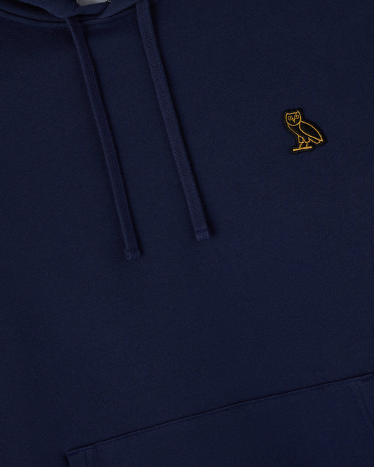Navy hoodie with drawstring and small gold owl embroidered on chest.