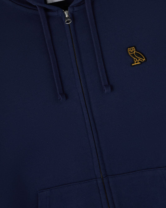 Navy full-zip hoodie with drawstring and small gold owl embroidered on chest.