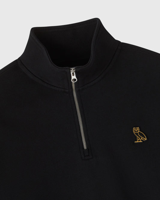 Black quarter zip mockneck sweatshirt with small gold owl embroidered on chest and metal zipper.