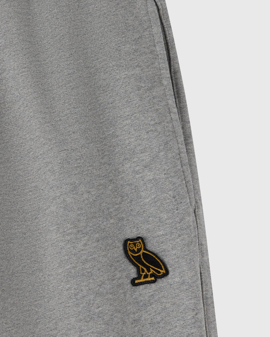 Heather grey sweatpant with ribbed texture and small embroidered owl logo on leg.