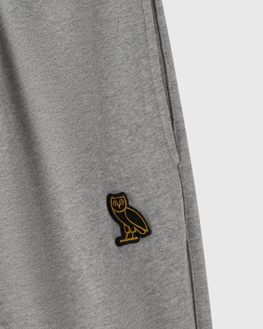Heather grey sweatpant with small embroidered owl logo on thigh.