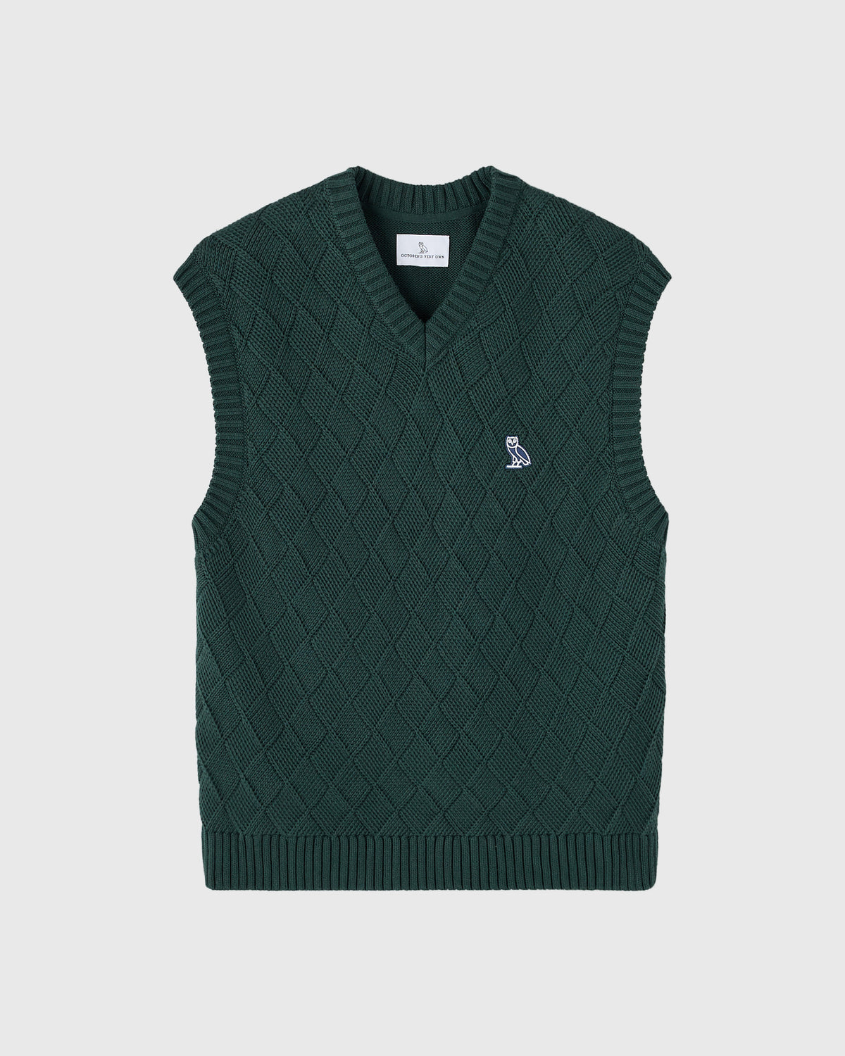 Midnight green basketweave knit sweater vest with V-neckline and small owl embroidered logo on chest.