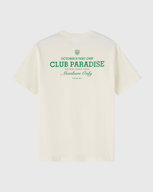 Cream short-sleeve t-shirt with green "Club Paradise" text and OVO logo on chest.