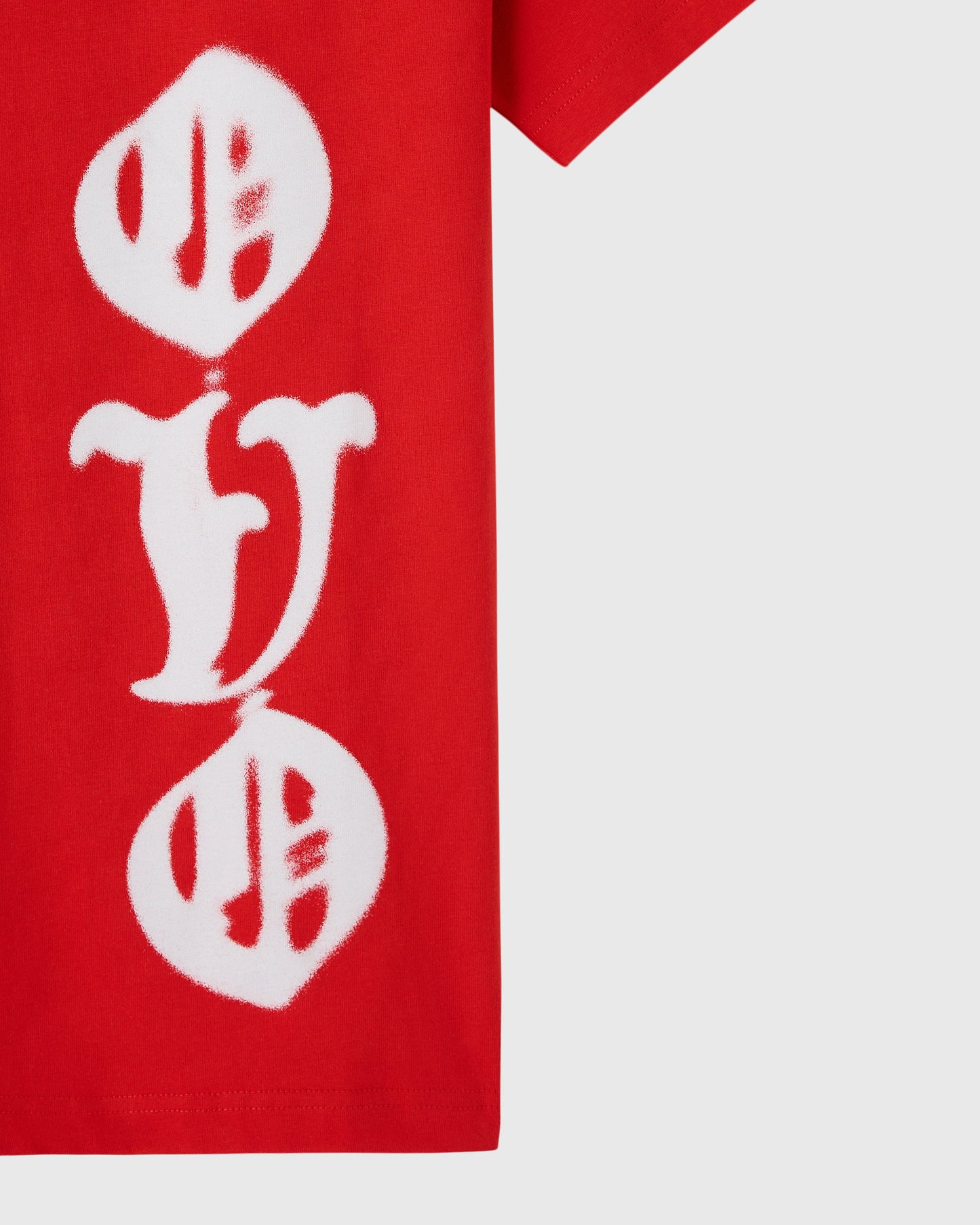 Red t-shirt with white airbrushed graphic featuring circular designs and central letter on front.