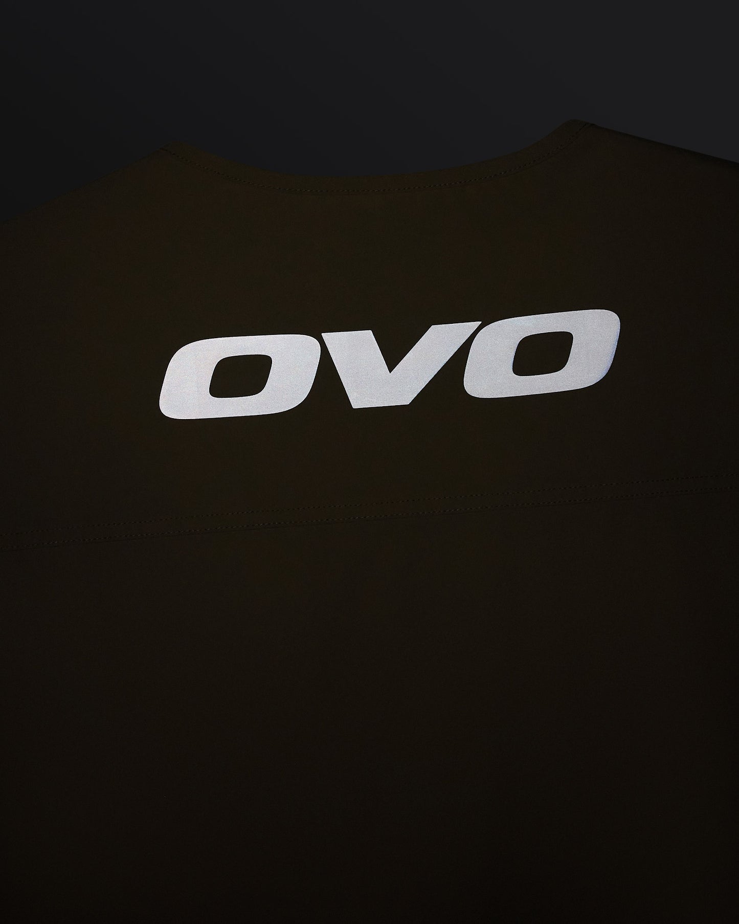 Sandstone-colored stretch nylon vest with white OVO logo on chest.