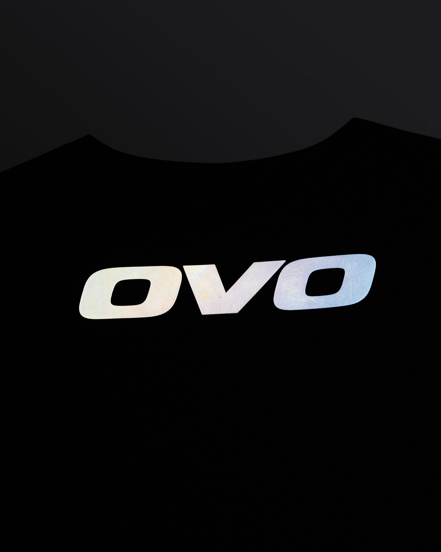 Midnight green sleeveless golf vest with OVO logo on chest displayed on dark background.