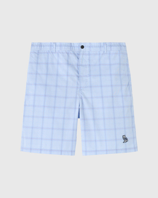 Light blue plaid camp shorts with button closure and small embroidered logo on lower leg.