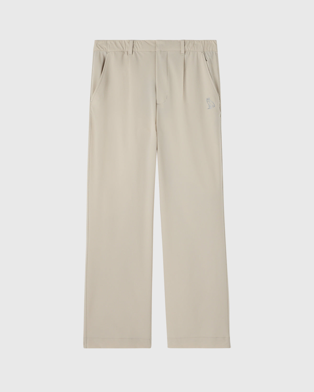 Sandstone stretch nylon chino pants with front pleats, side pockets, and small logo detail on thigh.