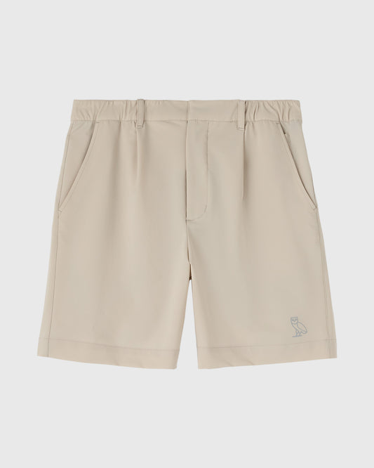 Sandstone stretch nylon golf shorts with front pockets and small owl logo on lower leg.