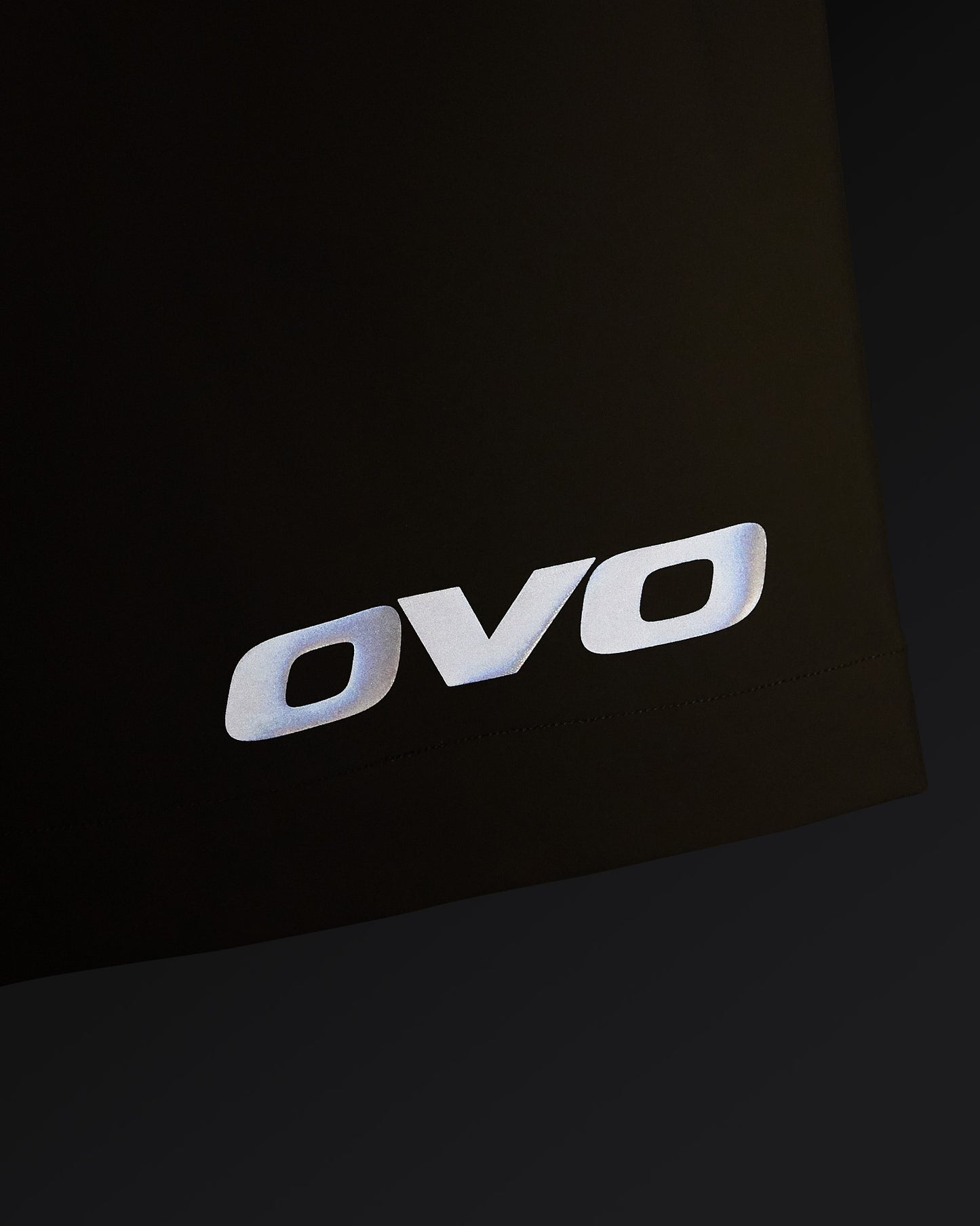 Sandstone and black OVO golf shorts with white OVO logo on thigh.