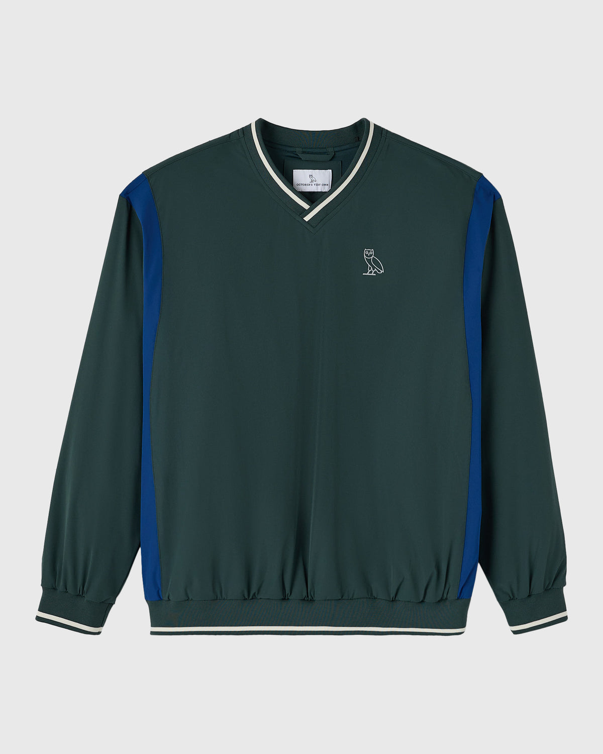 Midnight green v-neck pullover with blue side panels, white trim at neck and cuffs, and small owl emblem on chest.