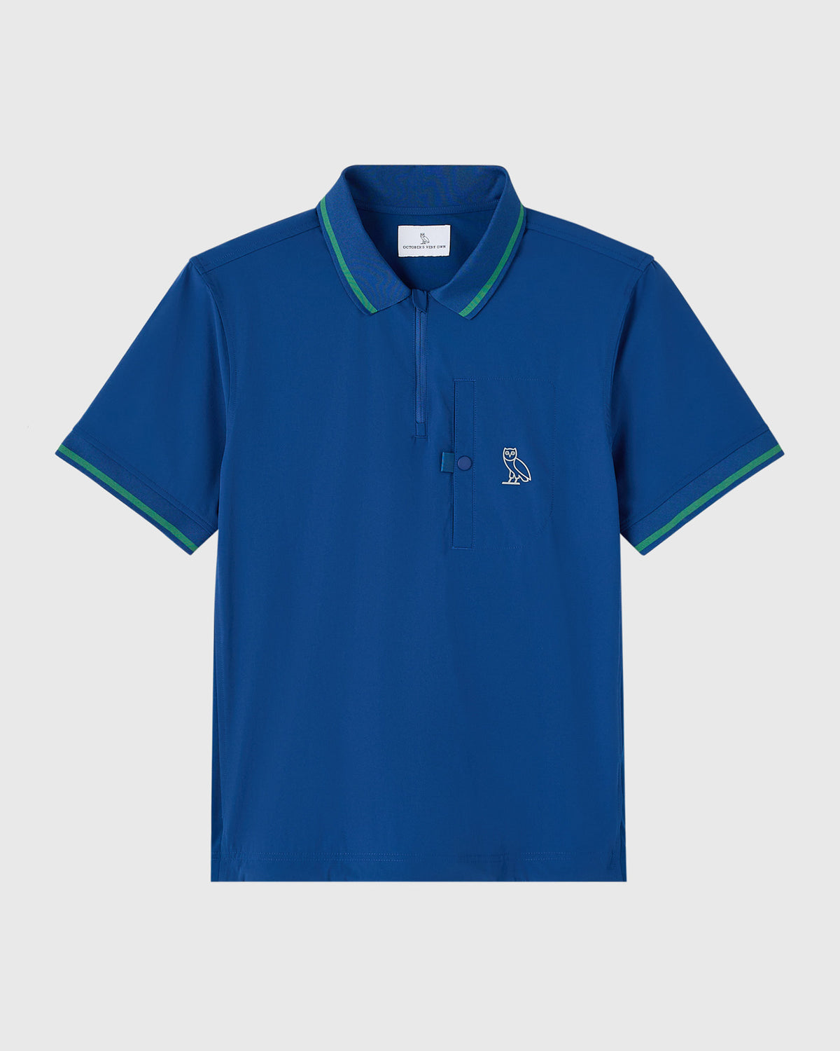 Deep denim blue polo shirt with green tipping on collar and sleeves, featuring OVO owl logo on chest.