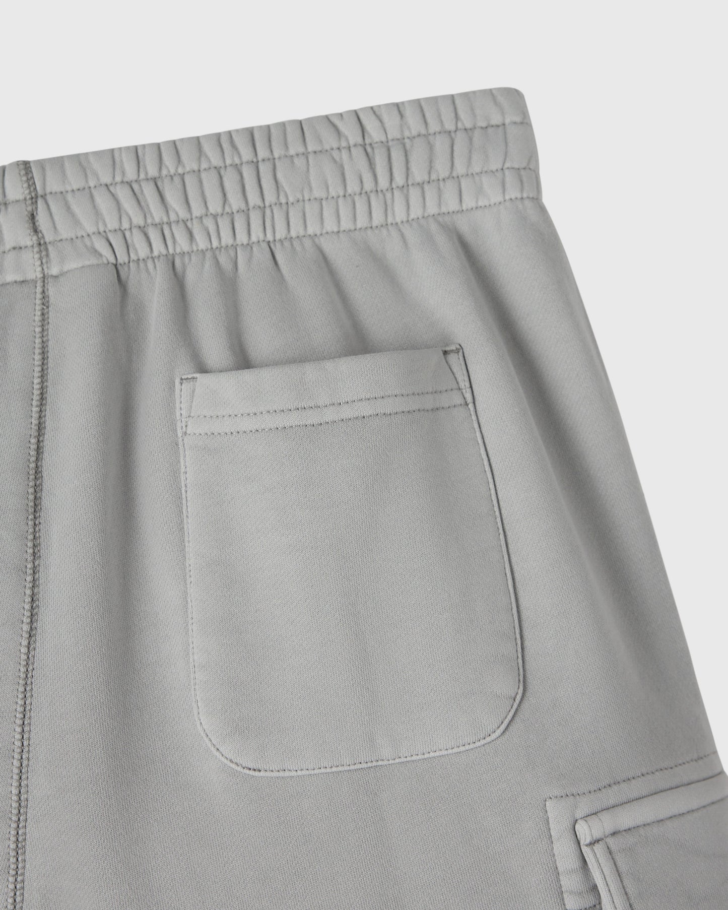 Gray sweatpant with elasticated waistband and cargo pocket detail on thigh.