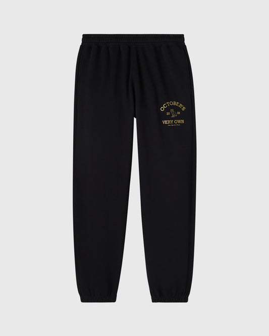Black sweatpants with gold embroidered "Octobers Very Own" text on thigh.