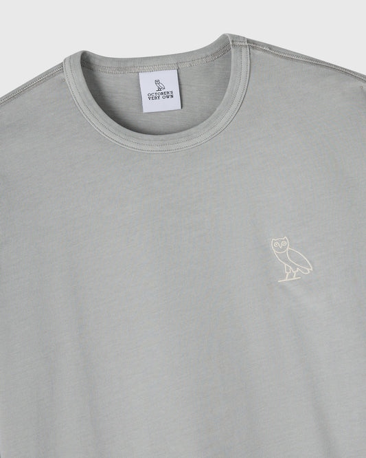Gray long-sleeve crewneck tee with small owl embroidery on chest and October's Very Own brand label.