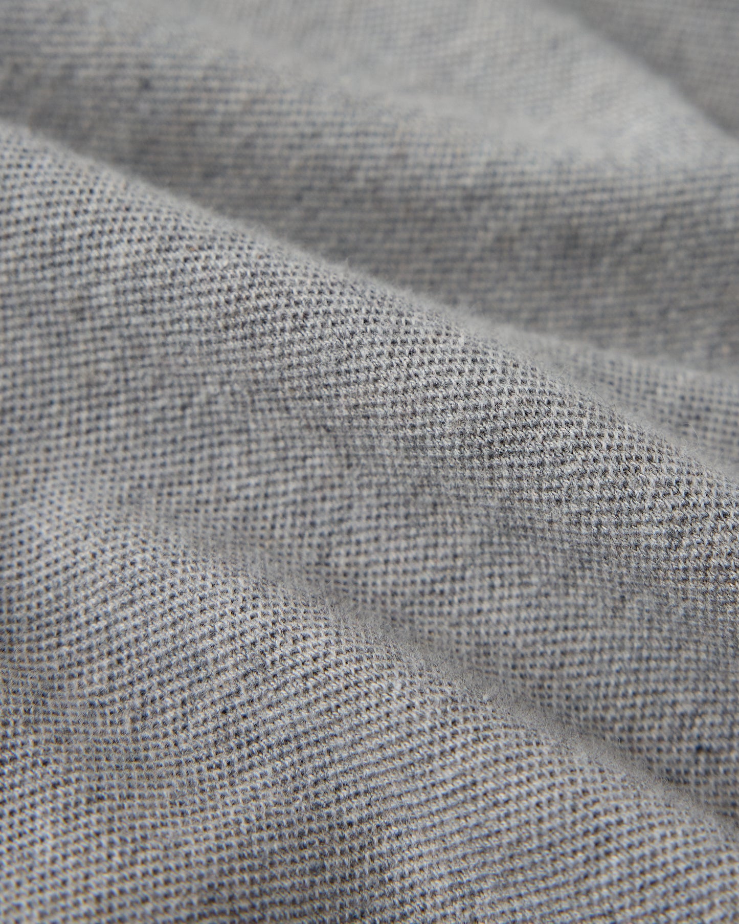 Heather grey polo shirt with textured cotton piqué weave fabric and collar detail.