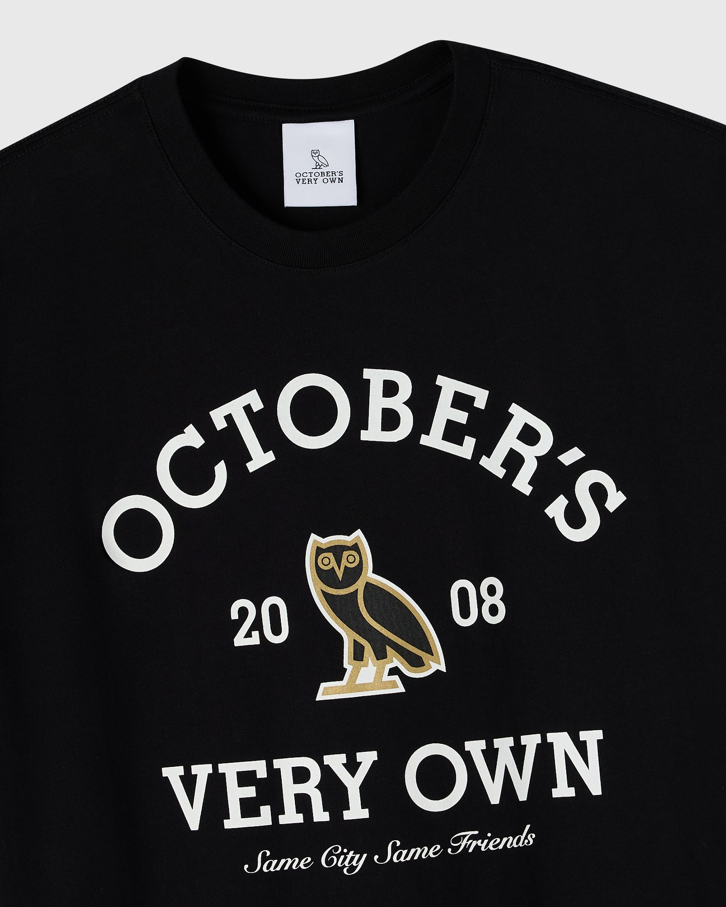 Black crew neck tee with white text reading "October's Very Own" and gold owl graphic with "2008" and "Same City Same Friends
