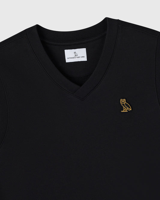 Black sleeveless vest with v-neckline and small gold owl embroidery on chest.