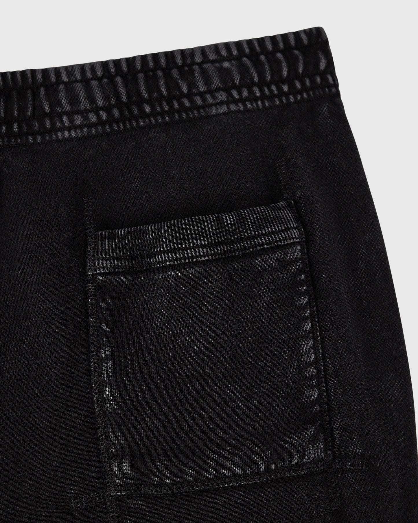 Black sweatpant with ribbed waistband and cargo pocket detail visible on the leg.