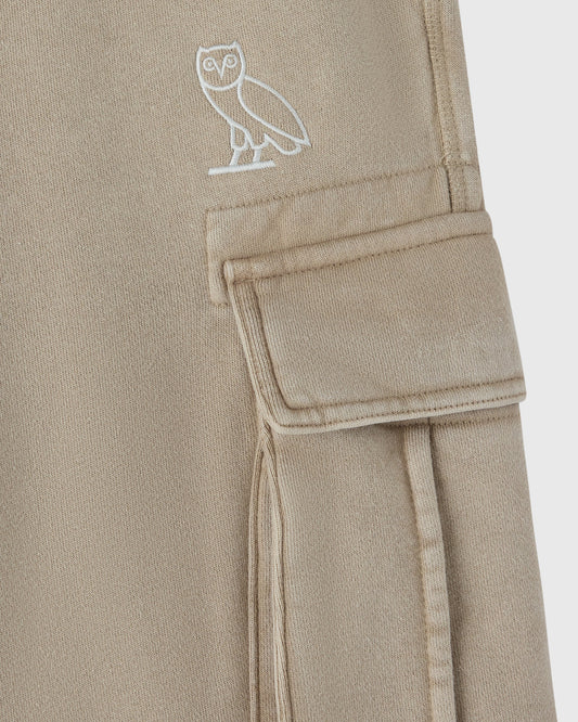 Sandstone cargo sweatpant with white owl embroidery on thigh and cargo pocket detail.