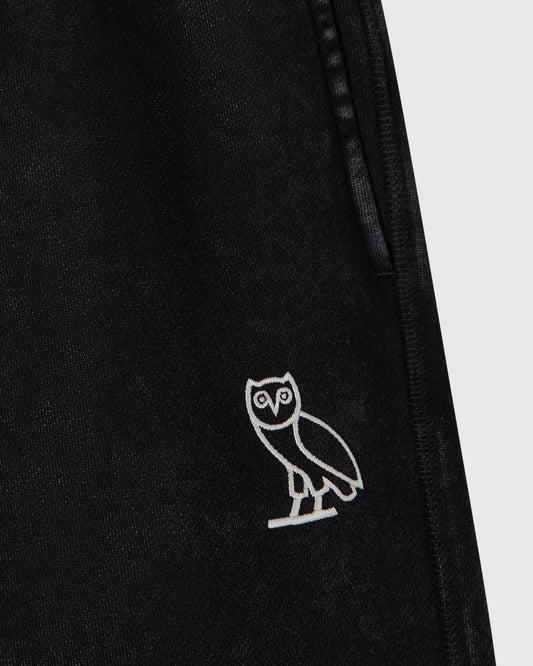 Black sweatpants with white owl embroidery on leg and side seam detail.