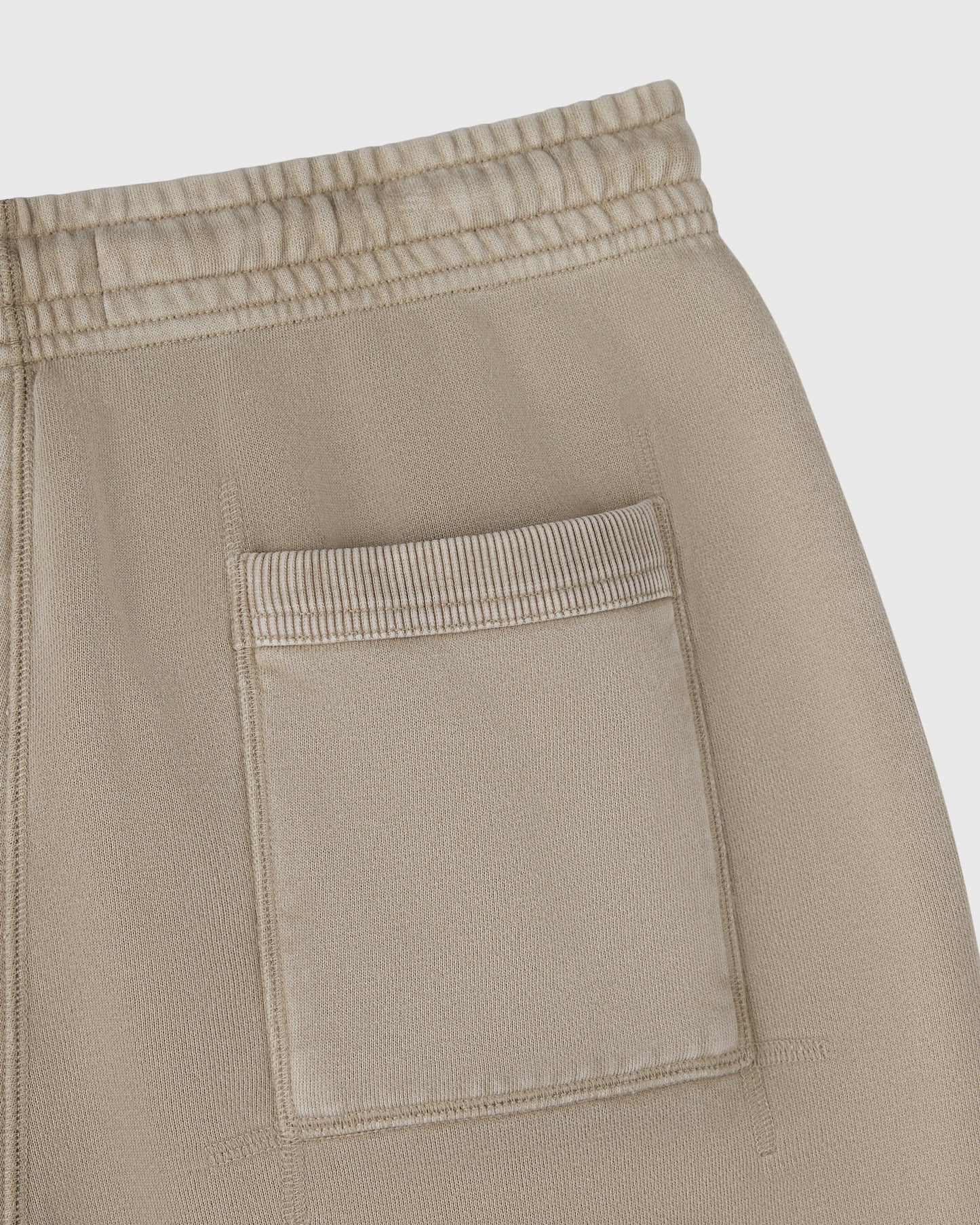 Sandstone sweatshorts with drawstring waistband and patch pocket detail.