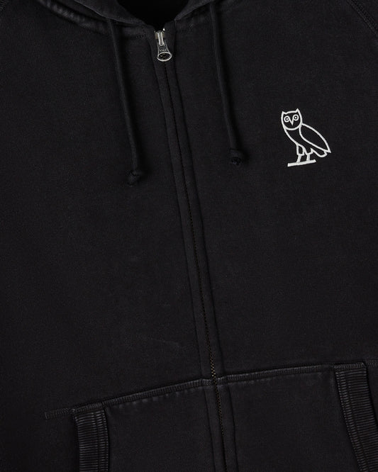 Black full-zip hoodie with white owl embroidery on chest, drawstring hood, and ribbed cuffs.