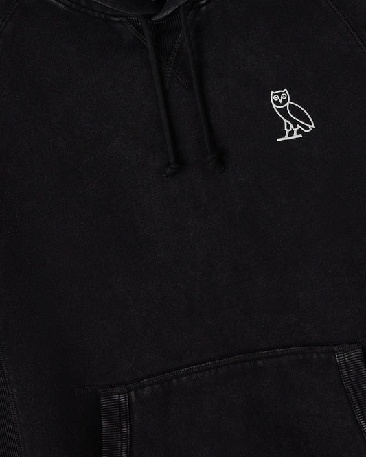 Black raglan hoodie with white owl embroidery on chest and drawstring hood.