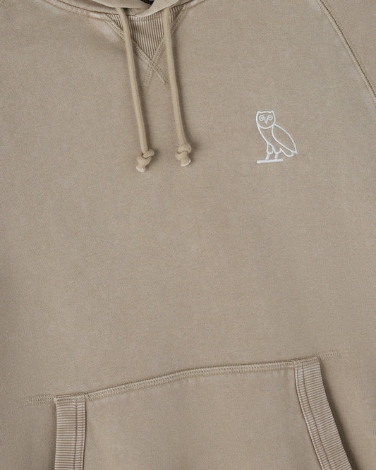 Sandstone raglan hoodie with white owl embroidery on chest and drawstring hood.