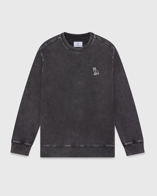 Black garment-dyed crewneck sweatshirt with small owl embroidery on chest and ribbed cuffs.
