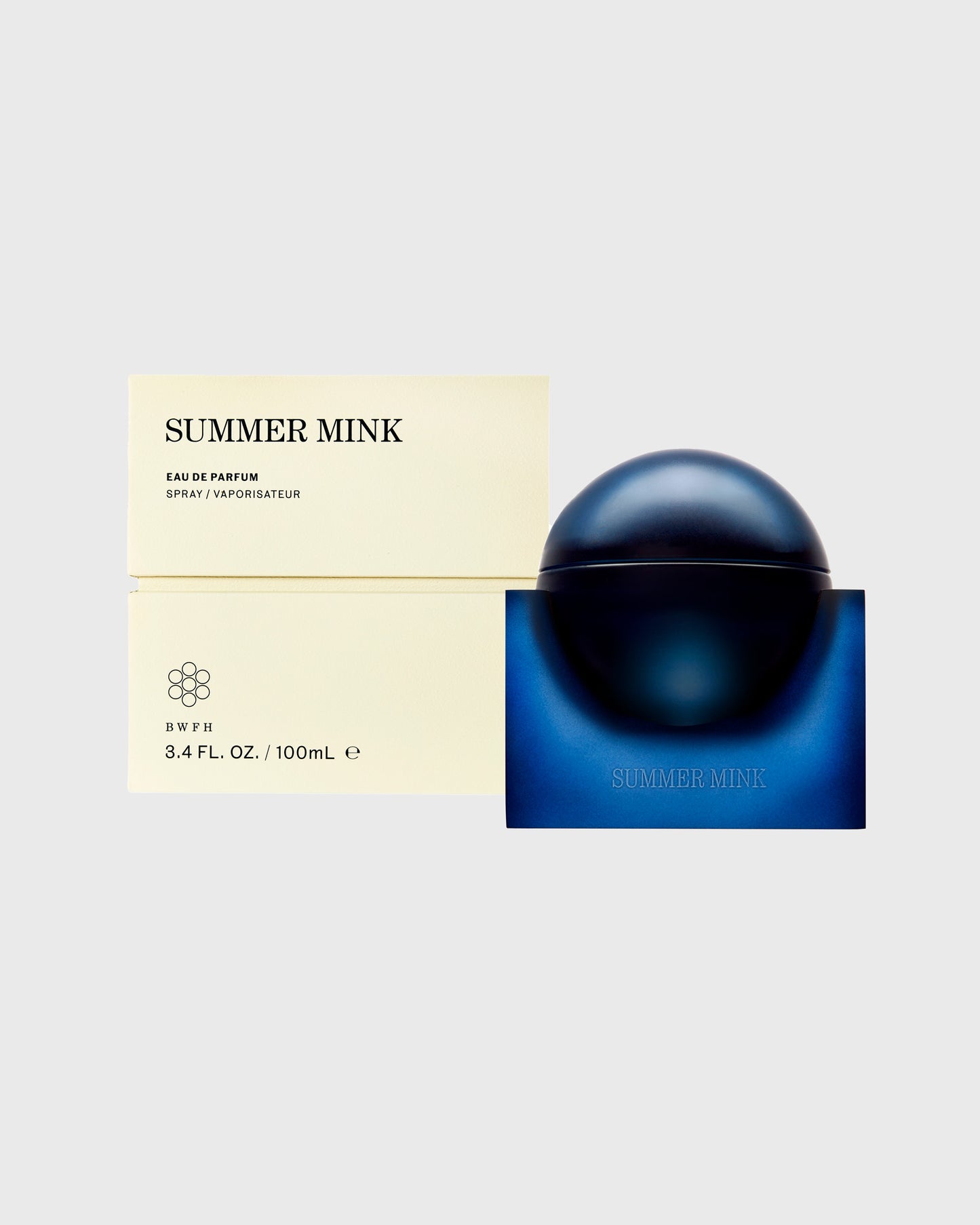 Summer Mink Eau de Parfum 100ml bottle with dark spherical cap and blue base box next to cream-colored packaging.