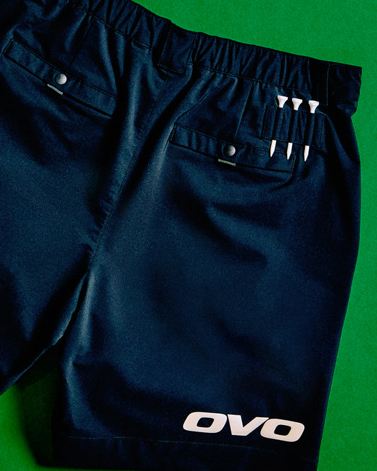 Black stretch nylon golf shorts with elastic waistband, front pockets, and OVO branding on leg.
