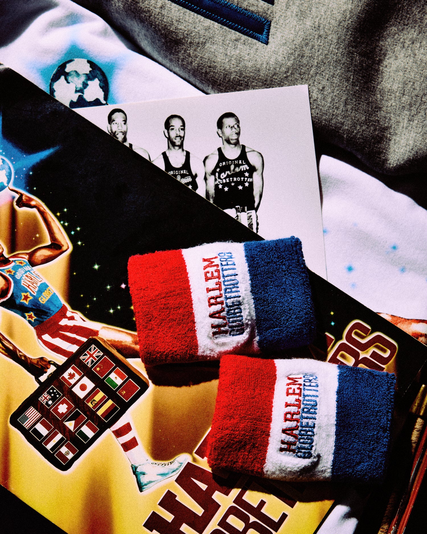 Harlem Globetrotters wristbands with promotional materials on a textured surface