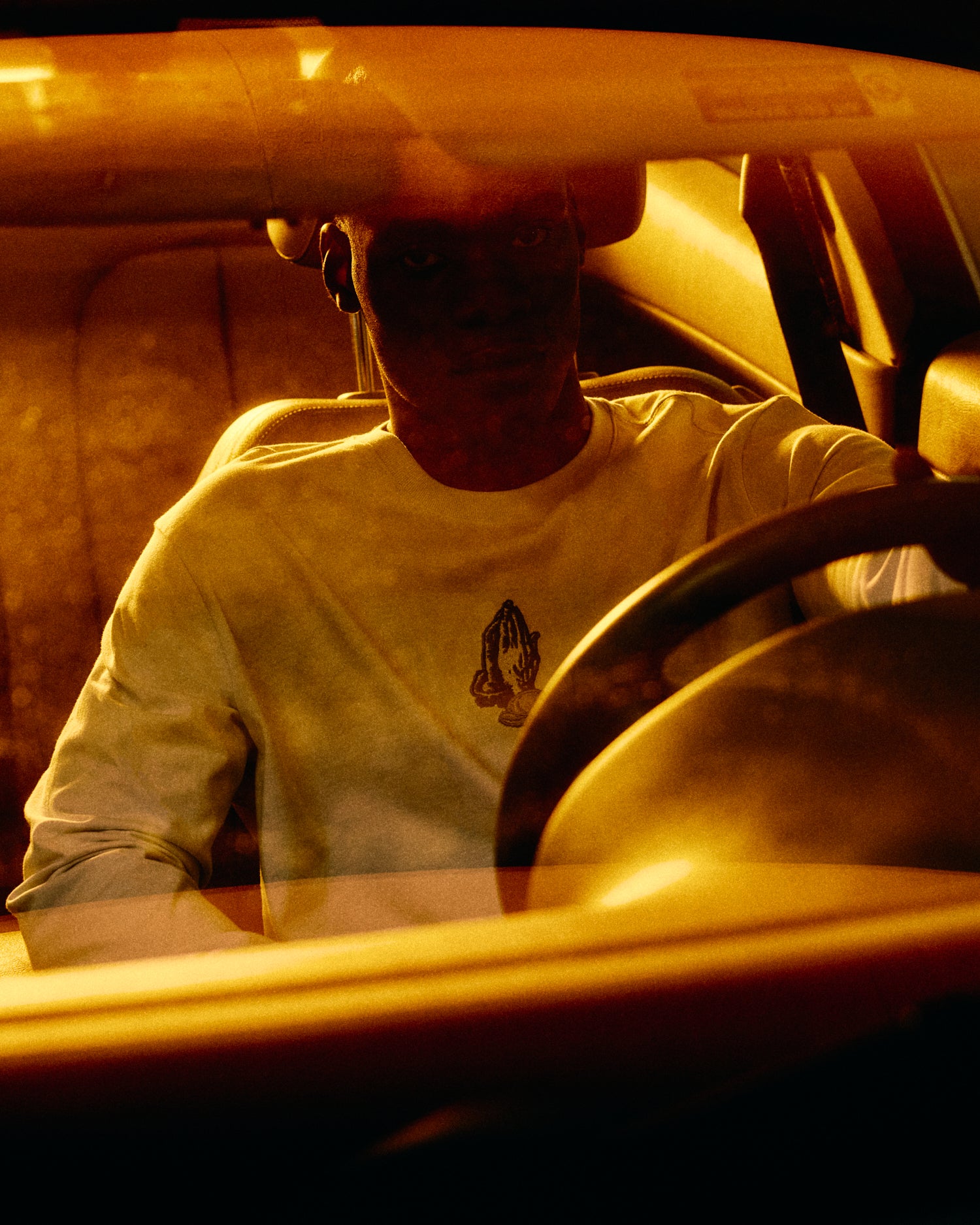 Person sitting inside a vehicle with warm lighting