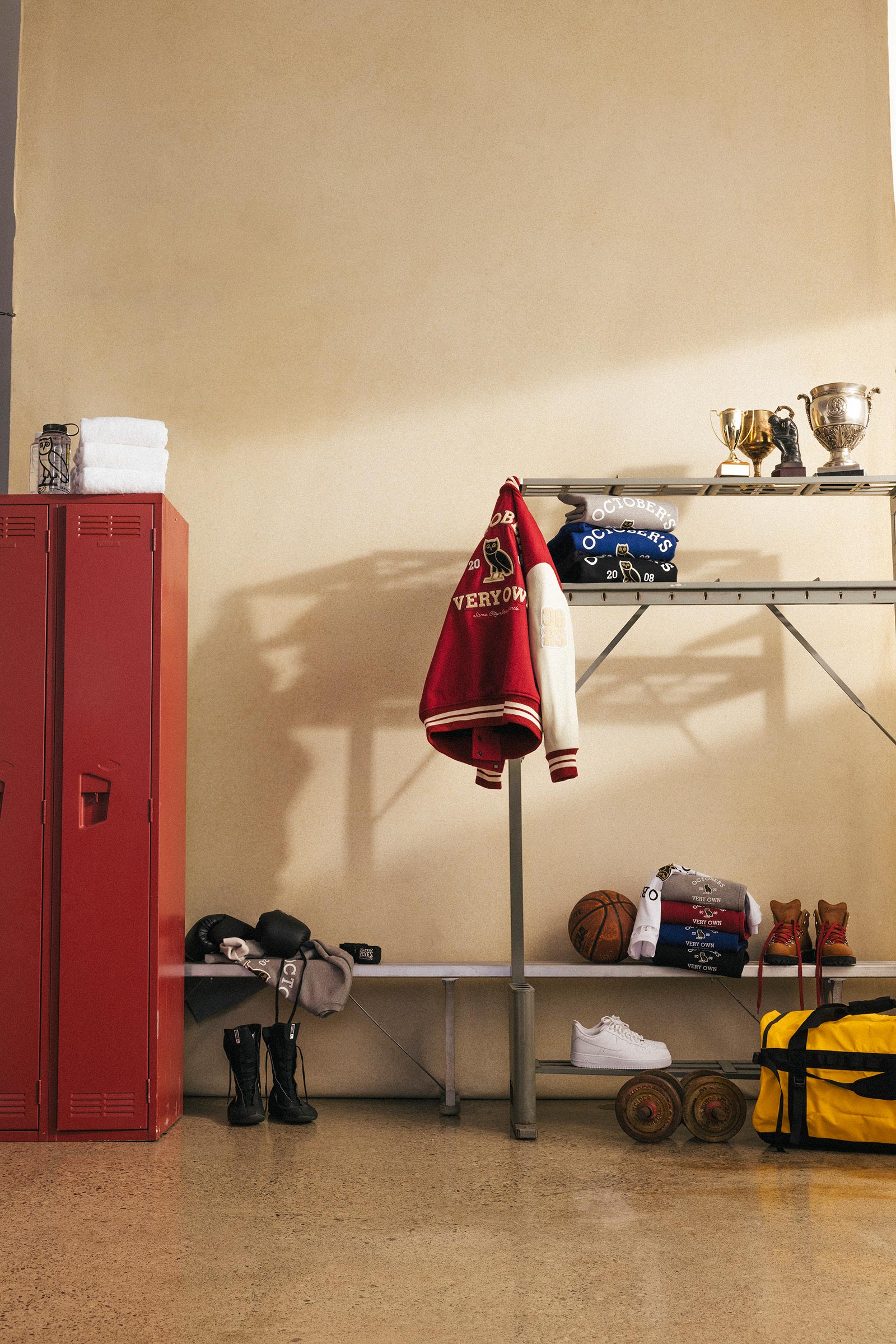 October's Very Own Collegiate Collection varsity hanging on sports rack in locker room.