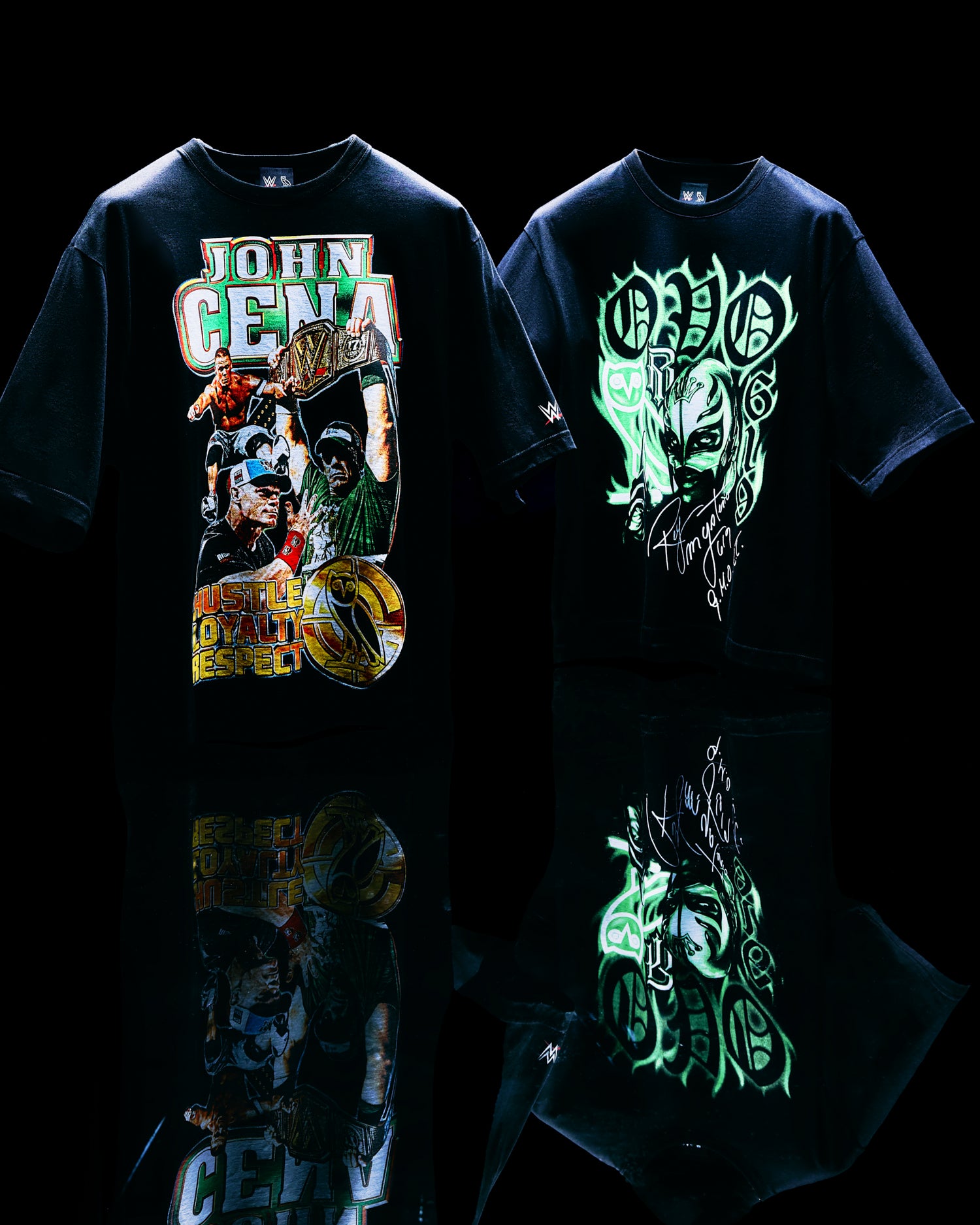 Two black October's Very Own x WWE t-shirts with graphic designs on a reflective surface.