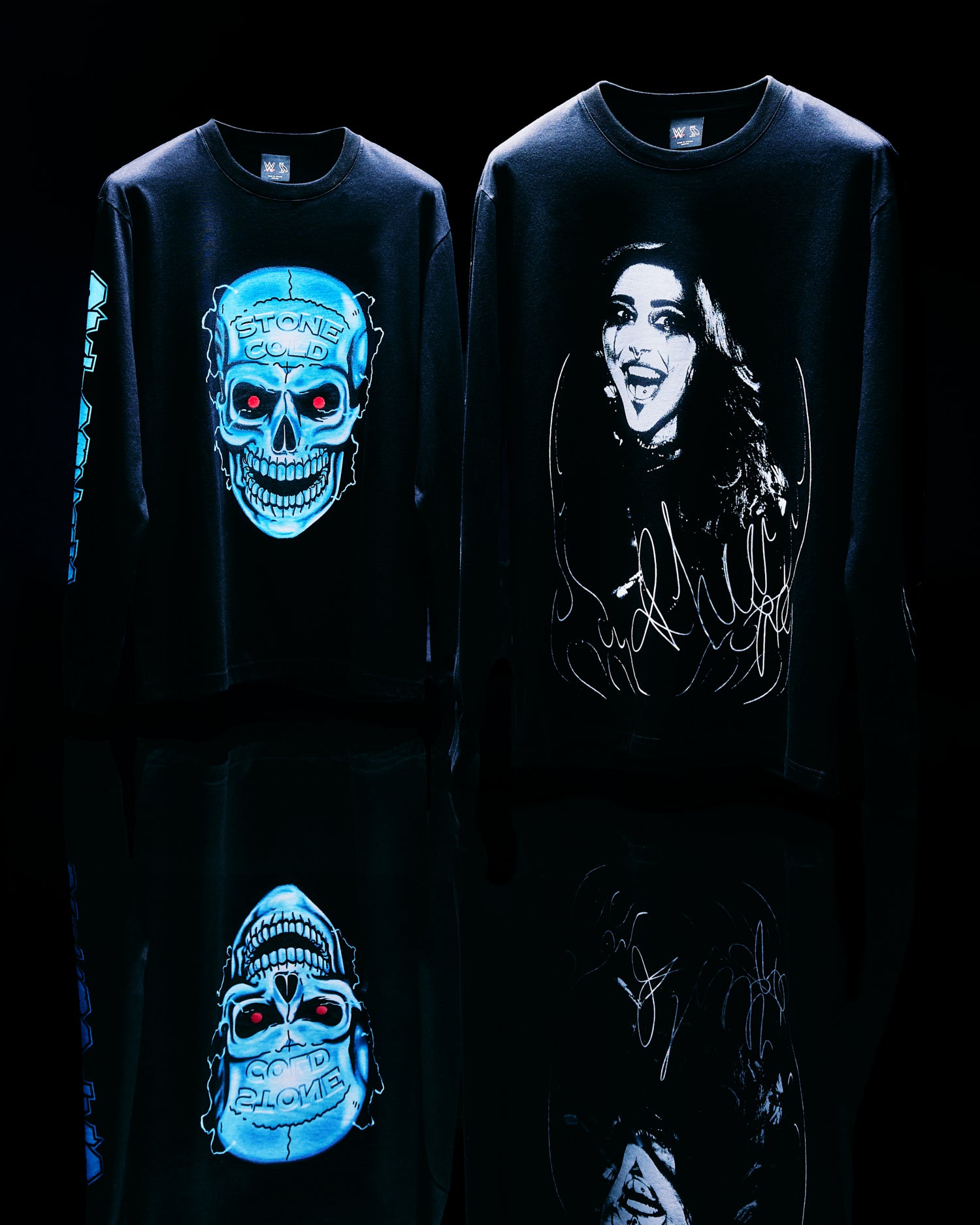 Two black October's Very Own x WWE long-sleeve shirts with graphic designs on a dark background