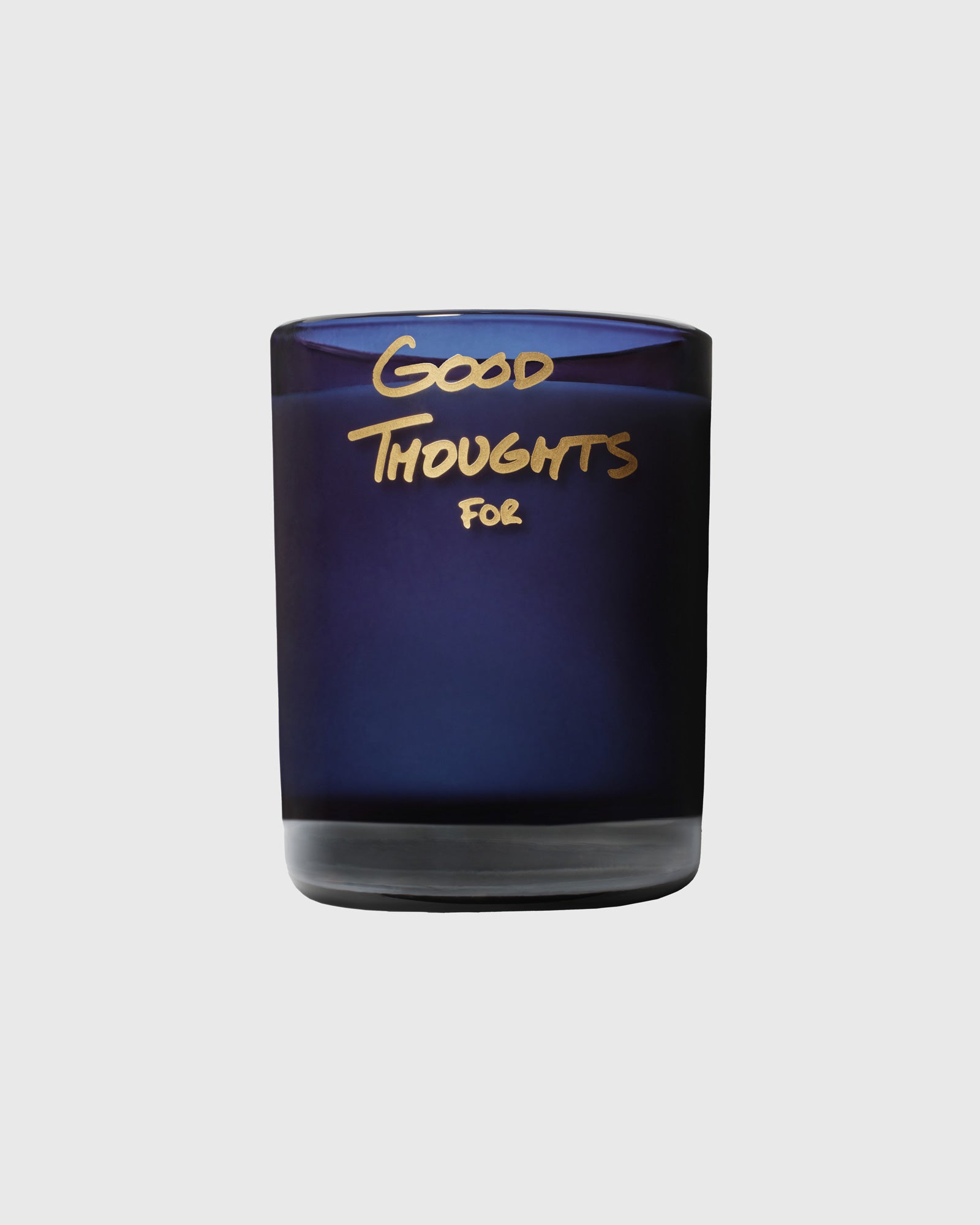 Navy glass candle with gold text reading "Good Thoughts For" on the label.