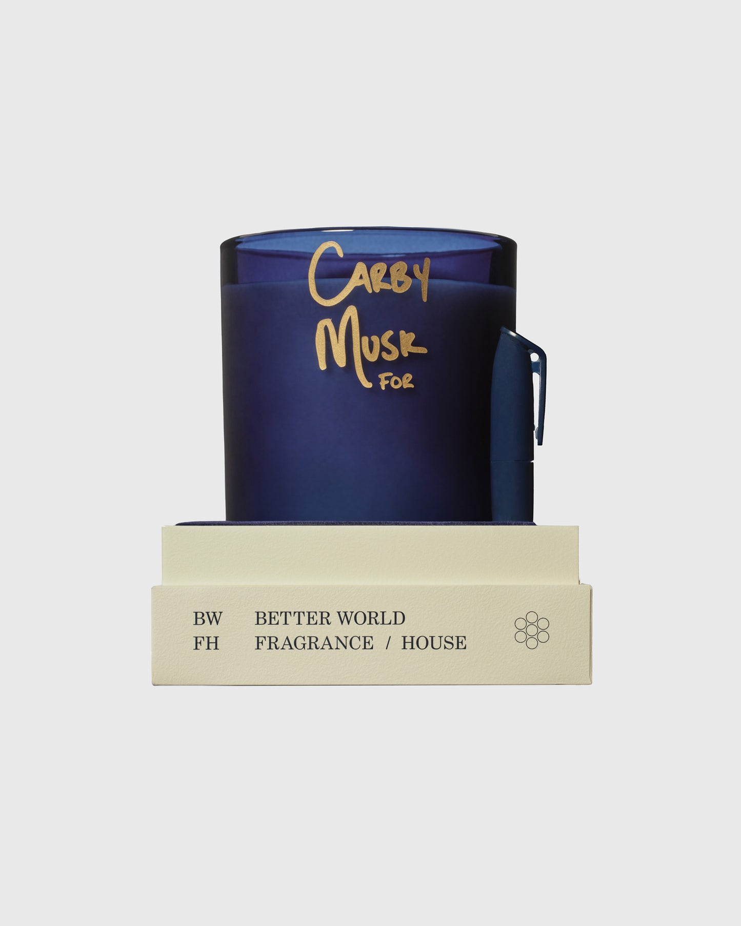 Dark blue candle with gold "Carby Musk" text and matching cream-colored box labeled Better World Fragrance House.