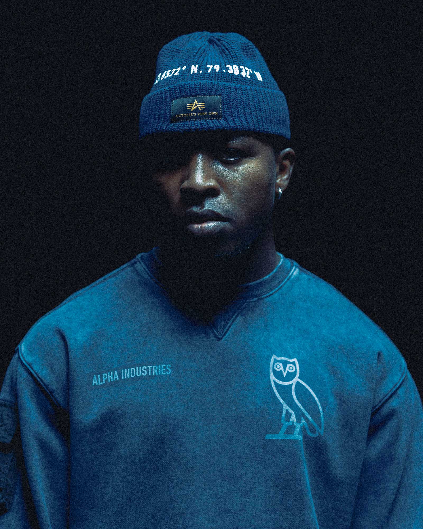Person wearing October's Very Own x Alpha Industries hat and sweater